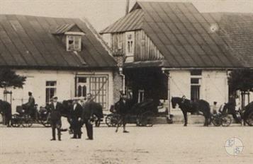 Fragment of postcard, 1933. There is a Chasid in traditional clothing in the center